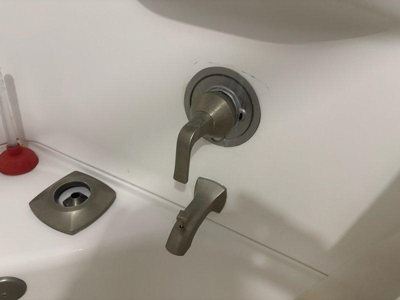 Responded to service call for Kohler shower system experiencing low water pressure and temperature control issues. Upon inspection, found shower valve was difficult to operate and inconsistent in maintaining desired water temperature. Assessed existing brushed nickel shower fixtures including single-handle valve assembly and diverter spout. Documented current installation with photos showing wall-mounted faucet assembly with circular escutcheon plate and overhead showerhead with multi-spray nozzles. Provided customer with detailed estimates for fixture replacement and valve repair options to resolve operational concerns.