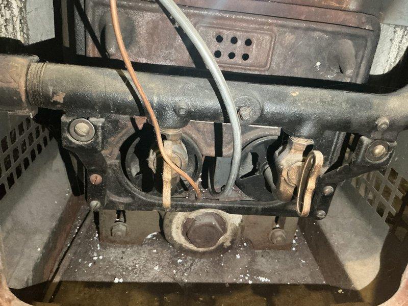 Performed comprehensive boiler tune-up and safety inspection on 40+ year old heating system. Upon inspection, discovered failed backflow preventer and pressure relief valve requiring manual filling operation. Safety testing revealed dangerous carbon monoxide levels exceeding 100 ppm in the flue, with spillage levels at 9 ppm at the maximum allowable threshold. Heat exchanger found severely plugged with rust and corrosion, identified as probable source of water leakage from the unit. Due to critical safety concerns and CO spillage, unit determined to be borderline unsafe for continued operation. Documented all findings with photographic evidence showing extensive rust, aged burner assembly, and deteriorated internal components. Scheduled same-day estimate for boiler replacement due to unsafe operating conditions.