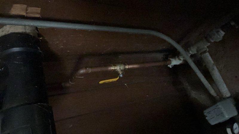 Responded to a basement water leak caused by a cracked barbed fitting on the well water supply line. Replaced the damaged barbed fitting and installed a new main shutoff valve on the pipe to provide proper water control and isolation capability for the well system.