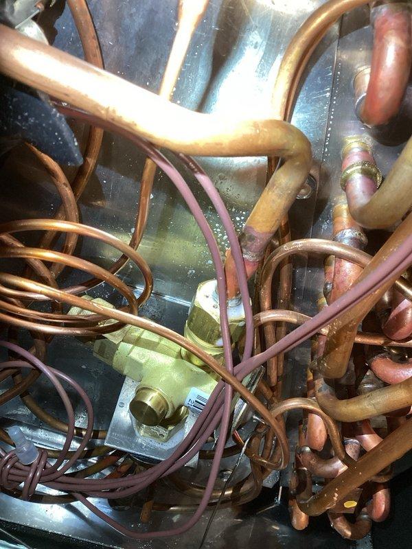 Completed warranty repair on a Unico 4-ton system by replacing a failed thermostatic expansion valve (TXV-4T-454). Evacuated and recharged the system with refrigerant to manufacturer specifications, verified proper refrigerant levels, and confirmed optimal temperature split across the evaporator coil. Adjusted blower speed settings and reconnected thermostat to ensure proper system operation and cycling.
