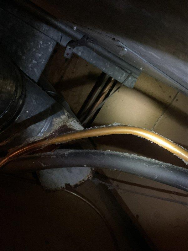 Responded to inspection correction for failed water heater venting system. Removed deteriorated 6-inch B-vent tee that had rusted through, compromising proper exhaust ventilation. Procured replacement components and installed new B-vent tee with proper cap to restore safe venting operation. All work completed in confined attic space with existing copper plumbing and HVAC ductwork present. System tested and verified for proper draft and secure connections upon completion.
