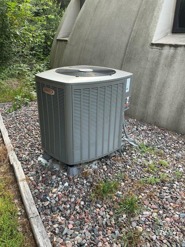 Responded to service call for air source heat pump system displaying low battery indicator on thermostat. Diagnosed issue as depleted batteries in outdoor temperature sensor. Located wireless outdoor sensor unit and demonstrated battery compartment access procedure to homeowner for future maintenance. Homeowner will obtain replacement batteries and complete installation.