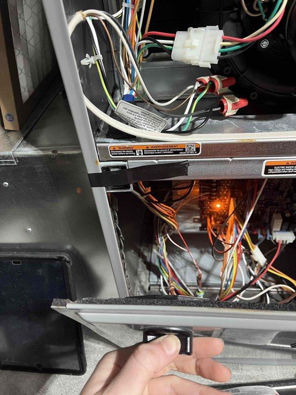 Responded to no-power complaint on Arcoaire furnace system. Upon inspection, determined the lower access panel was not fully engaging the safety interlock switch, preventing unit operation. Applied electrical tape to the switch button to ensure proper contact when door is closed. Verified proper door closure and tested system operation. Unit restored to normal heating function.