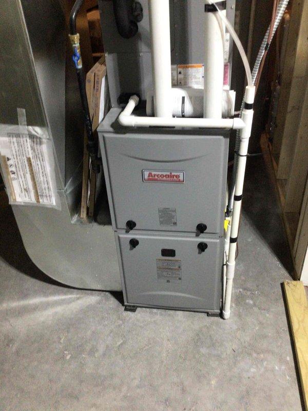 Responded to no-power complaint on Arcoaire furnace system. Upon inspection, determined the lower access panel was not fully engaging the safety interlock switch, preventing unit operation. Applied electrical tape to the switch button to ensure proper contact when door is closed. Verified proper door closure and tested system operation. Unit restored to normal heating function.