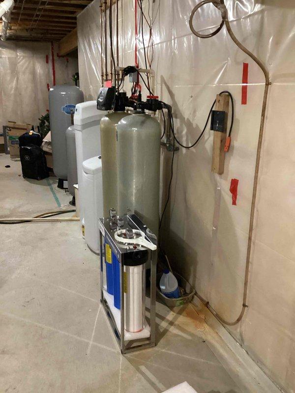 Conducted on-site assessment for installation of hot and cold water supply lines to accommodate a new sink in the garage. Evaluated existing plumbing infrastructure in basement utility area, including water treatment system with dual fiberglass tanks and filtration assembly, to determine optimal connection points for new branch lines. Provided estimate for running copper supply lines from main distribution system to garage location.