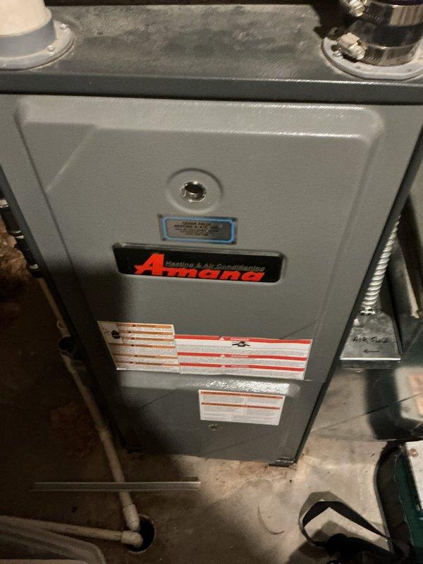 Completed preventive maintenance service on 13-year-old Amana air conditioning system. Performed comprehensive AC tune-up including system inspection, cleaning, and performance evaluation. A-coil showed moderate dust and debris accumulation consistent with system age, which was addressed during service. Air filter exhibited heavy soiling with significant dust buildup in pleated media, indicating extended service period. Cleaned components, verified system operation, and documented equipment condition with photos for maintenance records.