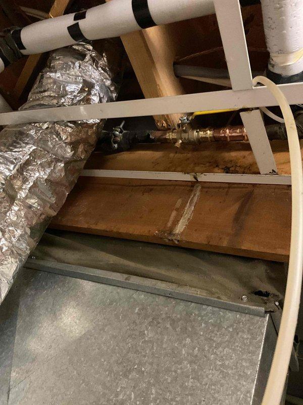 Completed water valve replacement in conjunction with recent HVAC furnace installation. Accessed utility area and crawl space to replace existing valve with new unit as specified during original system sale. Modified plumbing connections to accommodate new HVAC equipment requirements, ensuring proper water supply integration with heating system. Verified all connections for leaks, tested valve operation, and confirmed compatibility with newly installed furnace. Work area included water heater vicinity and overhead crawl space containing copper supply lines and PVC drainage pipes. All plumbing modifications completed to support HVAC installation specifications.