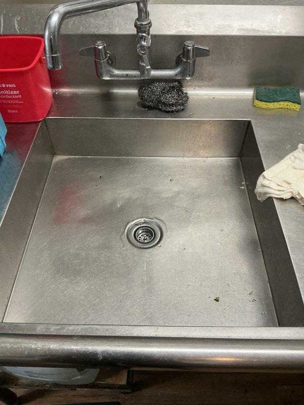 Responded to commercial kitchen sink drain issue. Upon inspection, found existing basket strainer severely corroded with broken threads, rendering it non-functional and unable to maintain proper seal. Removed deteriorated basket strainer assembly and cleaned drain opening. Installed new basket strainer with proper sealing to ensure leak-free operation and restored full drainage functionality to the commercial sink system.