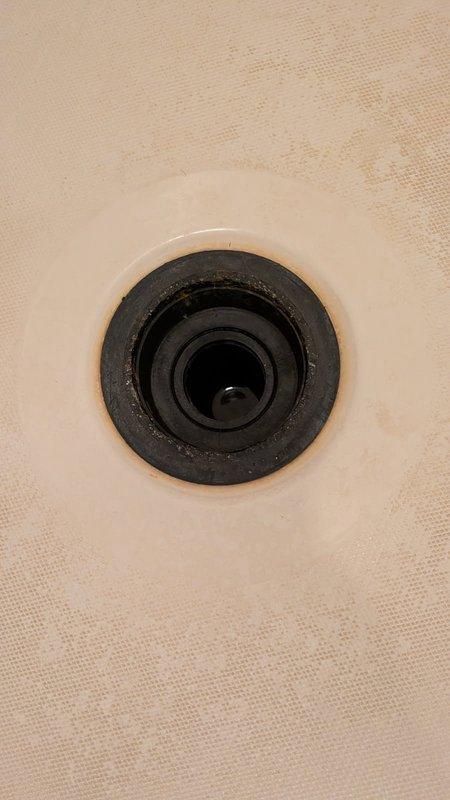 Responded to shower drain leak in fiberglass insert unit. Upon inspection, confirmed drain assembly was the source of active water intrusion causing ceiling damage below. Accessed leaking drain through existing ceiling opening that had been previously cut out. Removed failed drain assembly and installed new drain fixture with proper sealing to eliminate leak. Tested system to verify watertight seal and proper drainage function.