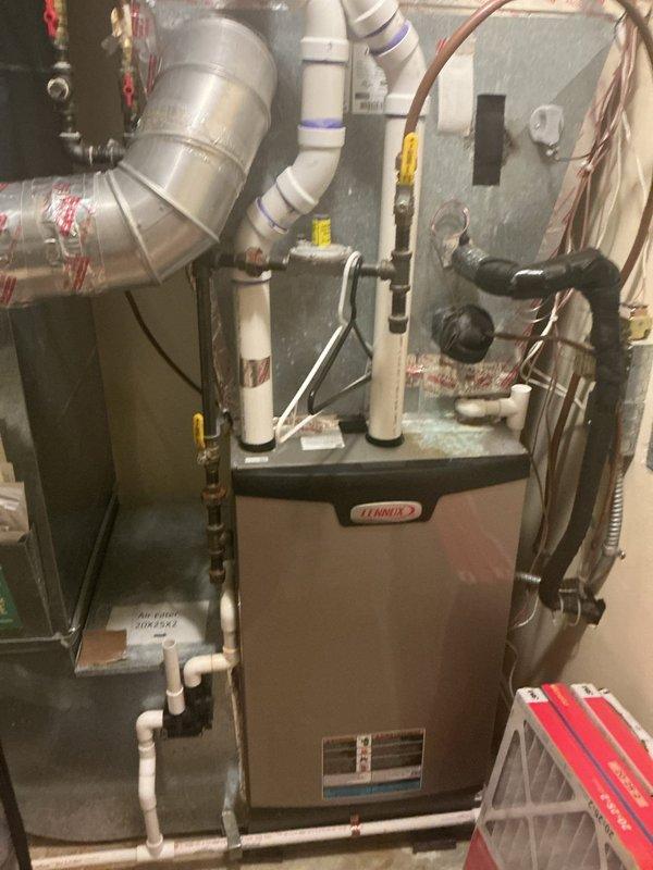 Completed comprehensive maintenance tune-up on dual-zone HVAC system including two furnaces and two air conditioning units. During inspection, identified upper level AC short-cycling issue occurring every 5-10 minutes due to improper low voltage wiring configuration at outdoor condenser. Diagnosed that control board was powered by jumper wire from Y terminal to R terminal rather than dedicated R wire from furnace, causing voltage drops and preventing system from maintaining adequate cooling. Consulted with Lennox technical support to confirm diagnosis and determine this wiring deficiency has existed since original installation. Verified both furnaces operating properly with all components testing within manufacturer specifications, gas pressure correct, and safe CO levels in flue. Confirmed main level AC system fully operational with proper refrigerant charge and all components within spec. Scheduled electrician to install dedicated R wire from upstairs furnace to outdoor condenser con