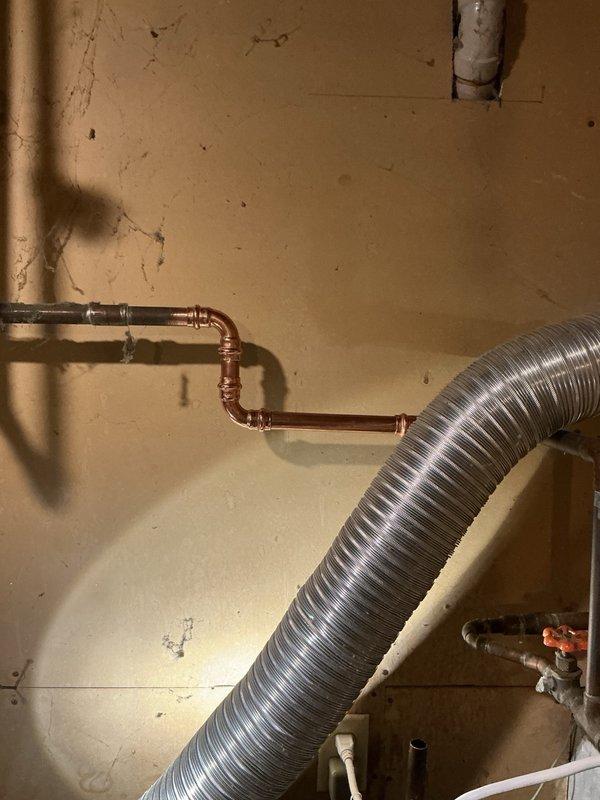 Responded to water leak emergency caused by malfunctioning water softener unit actively spraying water from rear connections. Upon customer request, removed non-functional water softener system completely from plumbing line. Cut out existing softener unit and reconfigured supply piping to bypass treatment system, establishing direct hard water connection to household plumbing. Restored water service without filtration or softening treatment as specified by customer.