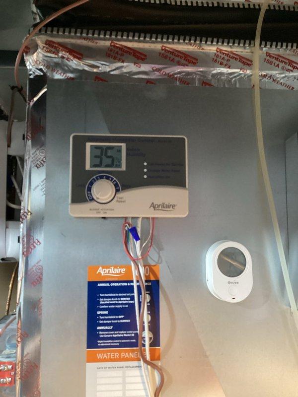 Responded to no cooling complaint on Mitsubishi Electric mini-split system installed 6 months prior. Upon arrival, outdoor unit was not running despite indoor unit powering on. System restored to full operation after homeowner cycled power at breaker while describing issue to technician. Consulted with technical support who confirmed unit likely entered fault state following power outage from backup generator cycling. Advised homeowner to cycle power at breaker panel if issue recurs. Inspected Aprilaire whole-home dehumidifier per homeowner concern regarding door sticking and humidity control. Verified dehumidifier operating within normal parameters but noted current duct configuration requires HVAC system blower operation for proper air circulation and dehumidification effectiveness. Documented equipment with photographs of outdoor condenser unit and dehumidifier control panel showing model and serial number information for service records.