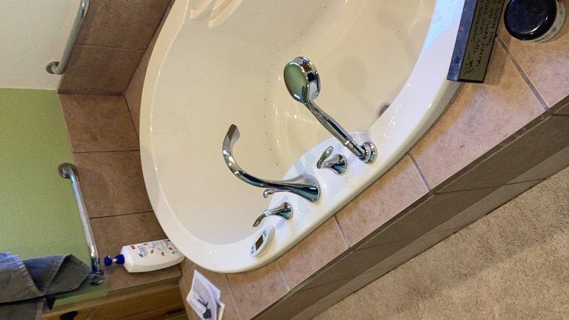 Responded to service call for malfunctioning tub filler diverter. Removed existing tub faucet and filler valve that was no longer diverting water properly. Cut access opening in basement ceiling drywall below the tub to reach plumbing connections. Installed new chrome tub filler valve and faucet assembly. Installed access panel in ceiling for future maintenance access. Tested all fixtures for proper water flow and diverter operation upon completion.