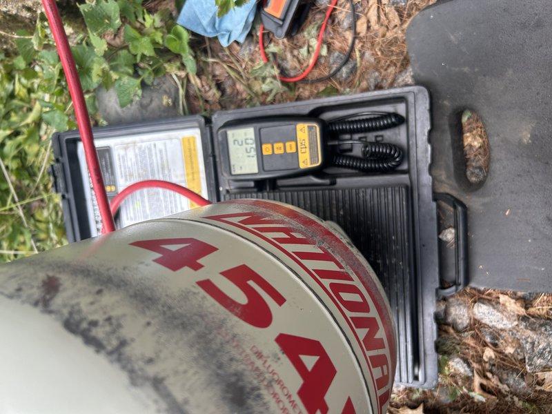 Responded to callback for mini-split system installed two days prior with flashing operation light and no cooling. Diagnosed 16-flash error code indicating refrigerant charge issue. Recovered refrigerant from system, confirming overcharge condition with 10 psi excess pressure. Evacuated system and weighed in manufacturer-specified refrigerant charge per unit specifications. System restored to operational status with improved cooling performance. Identified leaking service valves on both liquid and suction lines during diagnostic process. Documented findings and advised that unit replacement may be necessary due to defective service valves on new installation. Temporary repair completed to restore cooling capability.