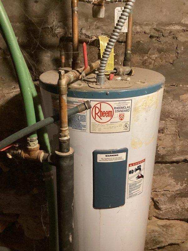 Responded to service call for inadequate hot water supply during shower use. Upon inspection, identified aging Rheem Rheemglas Standard tanked water heater at end of serviceable life, exhibiting reduced recovery rate and insufficient hot water production. Unit showed visible signs of deterioration including surface discoloration and wear consistent with extended service beyond typical lifespan. Documented unit specifications and current condition with photographs. Customer advised of equipment failure and provided estimates for standard water heater replacement and alternative boiler system options.
