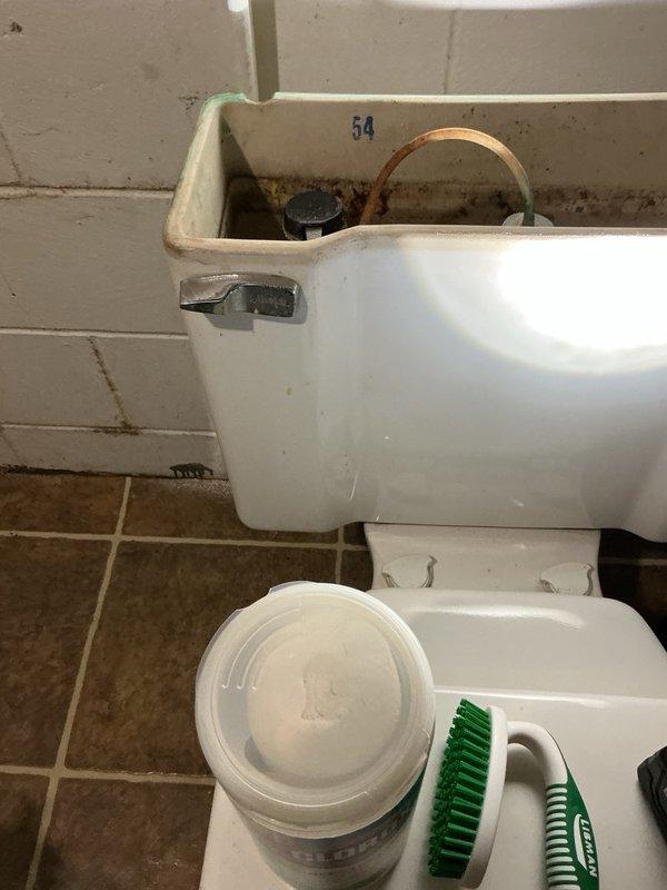Responded to service call for two malfunctioning toilets in residential property. Downstairs toilet experiencing continuous running issue was repaired by adjusting fill valve and removing accumulated sediment from tank, restoring proper operation. Upstairs toilet with chronic drainage problems requiring frequent plunging was replaced with new Gerber ADA-compliant unit due to age and deterioration of original 40-year-old fixture. During installation, identified soft subfloor condition and applied silicone sealant around toilet base to stabilize fixture and prevent movement. Advised property owner that underlying floor structure may require future repair or reinforcement if stability issues persist.