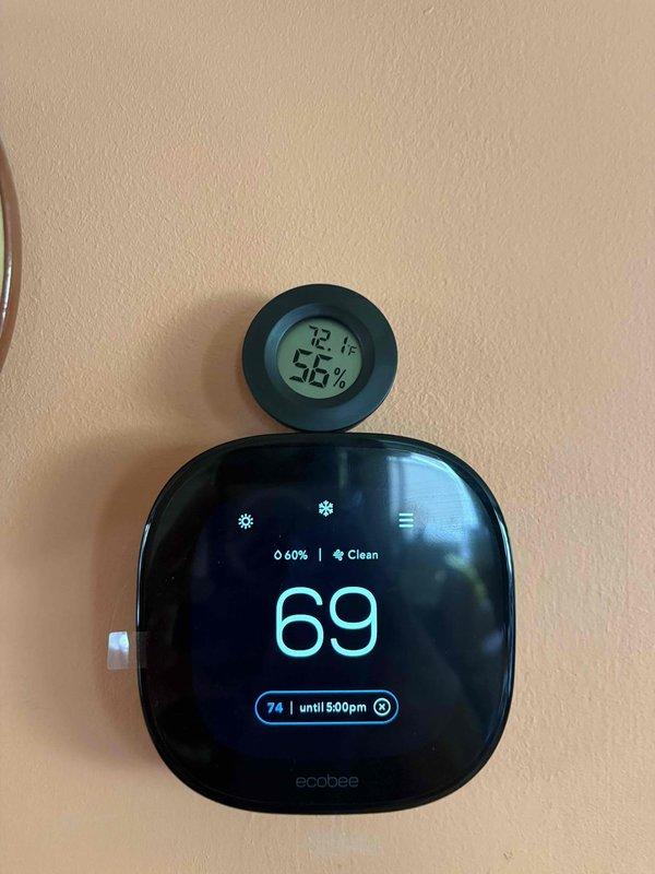 Responded to callback for dehumidifier not maintaining setpoint of 40% humidity, with indoor readings exceeding 60% despite outdoor conditions at 40%. Upon inspection, verified unit operates correctly in standalone dehumidifier mode with proper drainage function. Diagnosed issue as loss of external control capability from thermostat system—unit only responds to manual controls at equipment. Installed 3-amp fuses as required. Ecobee thermostat displaying 60% humidity while separate hygrometer reading 55%, indicating potential communication failure between dehumidifier and building automation system requiring further integration troubleshooting or control rewiring to restore automated humidity control functionality.
