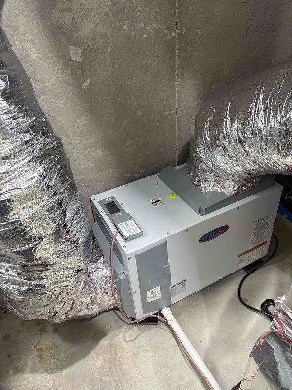 Responded to callback for dehumidifier not maintaining setpoint of 40% humidity, with indoor readings exceeding 60% despite outdoor conditions at 40%. Upon inspection, verified unit operates correctly in standalone dehumidifier mode with proper drainage function. Diagnosed issue as loss of external control capability from thermostat system—unit only responds to manual controls at equipment. Installed 3-amp fuses as required. Ecobee thermostat displaying 60% humidity while separate hygrometer reading 55%, indicating potential communication failure between dehumidifier and building automation system requiring further integration troubleshooting or control rewiring to restore automated humidity control functionality.
