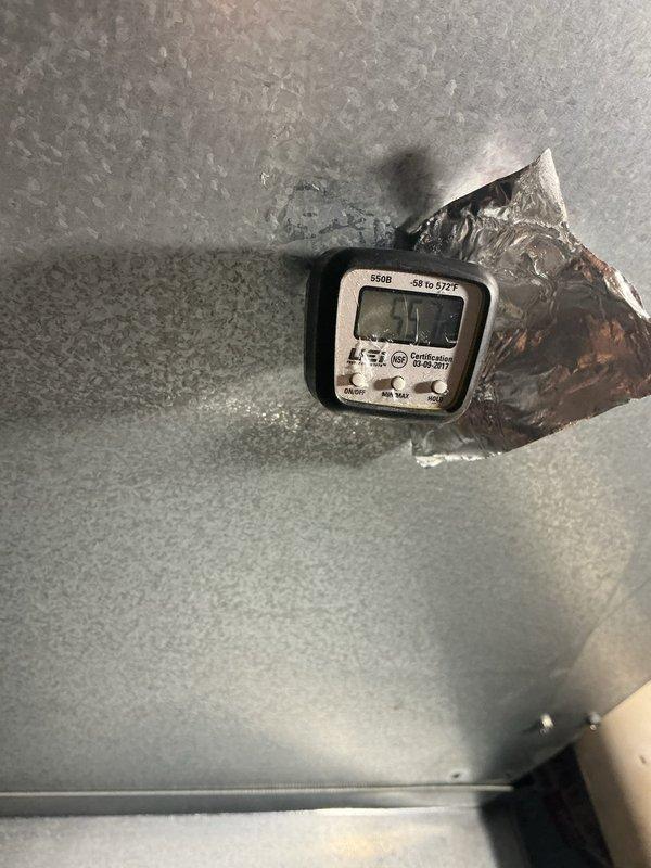 Responded to vague error message displayed at thermostat indicating potential AC malfunction. Performed comprehensive system diagnostics including blower fan speed verification, temperature split measurement (17 degrees), refrigerant pressure analysis, and electrical component testing of fan motor, compressor, capacitor, and contactor—all components tested within normal operating parameters. Subcooling measured slightly low and liquid line temperature slightly elevated, though system pressures remained acceptable. Removed restrictive air filter contributing to minor airflow restriction. System continued operating normally throughout diagnostic process with no fault codes recurring. Recommended installation of MERV 8 rated filter with quarterly replacement schedule to maintain optimal airflow and system performance. Unit confirmed fully operational upon service completion.