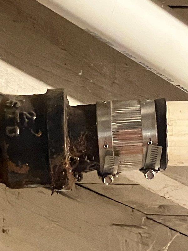 Responded to basement water leak occurring when air conditioning system was in operation. Upon inspection, identified severely corroded cast iron drain pipe under basement stairs with visible hole causing water discharge. Extensive rust damage and deterioration observed on cast iron plumbing connections and fittings. Documented condition of compromised piping system with photographs showing advanced corrosion on metal components and deteriorated pipe connections. Customer also reported water pooling in basement after using kitchen and bathroom sinks, consistent with failed drain line. Advised customer of need for cast iron pipe replacement due to extent of deterioration and recommended obtaining estimate for complete cast iron repipe to address systemic corrosion issues throughout drainage system.