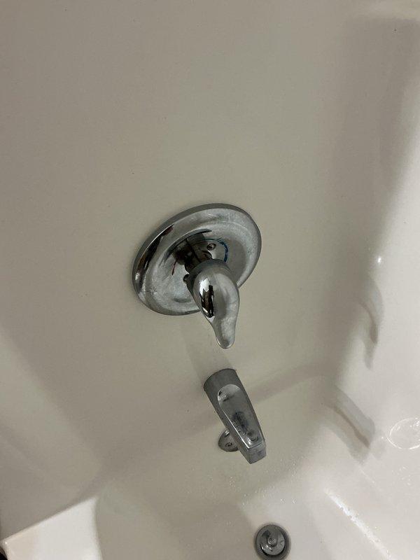 Responded to a callback for a Moen shower valve with a loose cartridge causing the handle to drift from the vertical position to full hot on its own, resulting in temperature fluctuations. Initially attempted replacement with a new cartridge, which exhibited the same issue due to excess factory grease on the internal barrel component. Resolved the problem by removing the barrel from the cartridge, wiping off the excess grease, and reinstalling, which restored proper friction and handle stability.