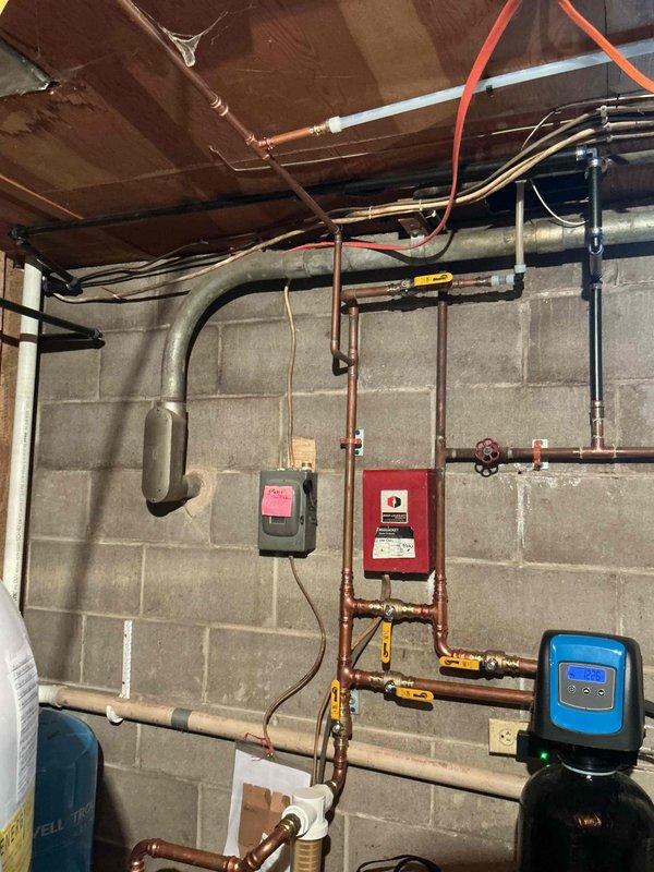 Responded to a plumbing correction where a hose bibb had been incorrectly connected to the softened water supply line instead of the hard water line from the well. Upon inspection, determined that the hose bibb was never properly piped to hard water when the water softener system was originally installed. Rerouted copper piping to connect the hose bibb directly to the hard water supply, bypassing the water softener system to provide untreated well water for outdoor use and prevent unnecessary wear on the softening equipment.