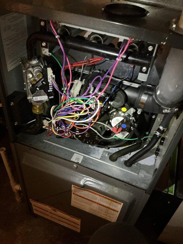 Responded to service call for reported blower motor failure on 4-year-old furnace identified during home inspection. Upon arrival, conducted thorough diagnostic evaluation of the unit. Blower motor tested and found to be functioning properly with no operational issues detected. During inspection, discovered moisture accumulation inside the furnace cabinet. Identified condensation issue and traced source to aging air conditioning system components. Documented findings with photographic evidence showing interior wiring, control board, filter assembly, and overall unit configuration. Advised homeowner of condensation concern and potential impact on system longevity. Homeowner declined further evaluation or service on the air conditioning system. Confirmed blower motor operational status and recommended monitoring for future concerns. No repairs required at this time.