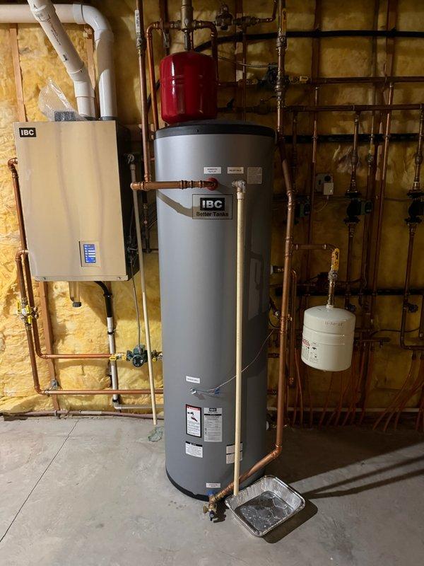 Responded to no hot water call for 5-year-old IBC boiler system controlling all domestic hot water through indirect-fired water heater. Upon arrival, found boiler control in fault condition. Reset and reconfigured the control system, then performed comprehensive diagnostic tests on all heating zones and loads to verify proper operation. System ran successfully through test cycles, but observed pressure relief valve dripping after extended runtime. Replaced defective temperature and pressure relief valve to prevent water loss and maintain safe system operation. Confirmed all zones functioning correctly and hot water restored to residence.