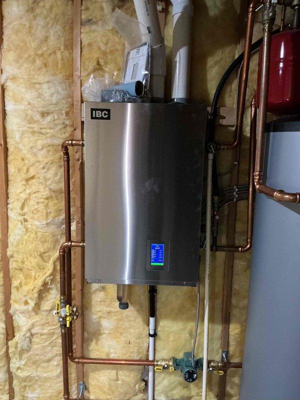 Responded to no hot water call for 5-year-old IBC boiler system controlling all domestic hot water through indirect-fired water heater. Upon arrival, found boiler control in fault condition. Reset and reconfigured the control system, then performed comprehensive diagnostic tests on all heating zones and loads to verify proper operation. System ran successfully through test cycles, but observed pressure relief valve dripping after extended runtime. Replaced defective temperature and pressure relief valve to prevent water loss and maintain safe system operation. Confirmed all zones functioning correctly and hot water restored to residence.