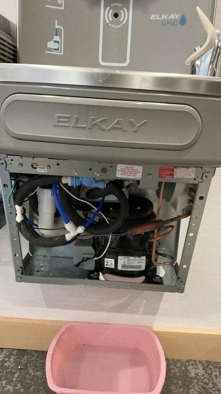 Responded to a significant water leak from an ELKAY bottle filling station and drinking fountain unit in the clinic area. Upon inspection, determined the evaporator was defective and beyond repair. Shut off water supply to the unit to prevent further leakage as requested, documented the faulty component with photographs, and submitted a purchase order for a replacement evaporator.