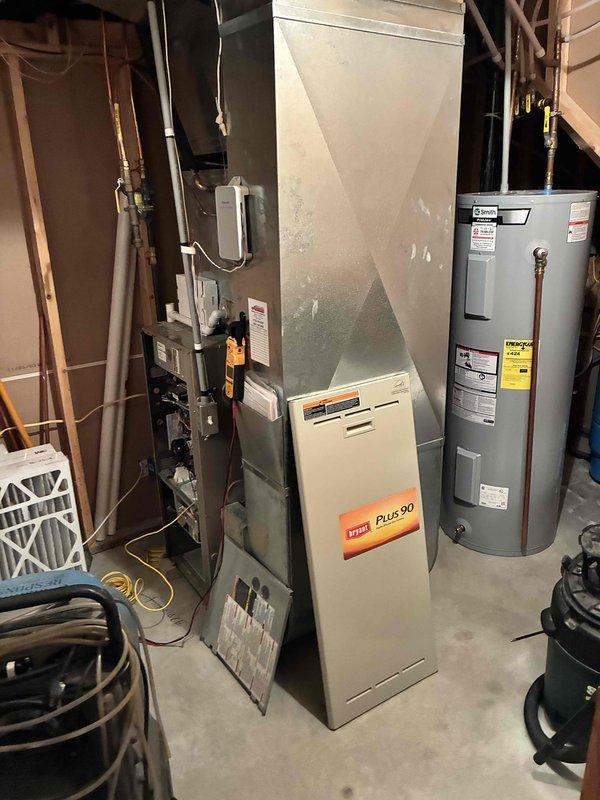 Responded to no cooling complaint on 5-year-old Bryant Plus 90 furnace with Honeywell Bluetooth thermostat displaying flashing error. Measured only 8 volts at thermostat terminals instead of required 24 volts, indicating low voltage power supply issue. Located blown low voltage fuse at furnace control board and temporarily installed 3-amp resettable breaker to diagnose root cause. Detected burnt odor near control board area during inspection.

Upon further diagnosis, observed blower relay rapidly cycling on and off, indicating failed control board causing excessive current draw that resulted in blown fuse. Control board determined to be defective and beyond repair. During comprehensive system inspection, discovered secondary heat exchanger showing signs of active leakage, which poses safety concern and indicates significant deterioration of furnace heat exchanger assembly.

Given the combination of failed control board requiring replacement and compromised heat exchanger integrity on a