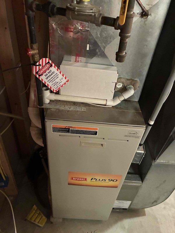 Responded to no cooling complaint on 5-year-old Bryant Plus 90 furnace with Honeywell Bluetooth thermostat displaying flashing error. Measured only 8 volts at thermostat terminals instead of required 24 volts, indicating low voltage power supply issue. Located blown low voltage fuse at furnace control board and temporarily installed 3-amp resettable breaker to diagnose root cause. Detected burnt odor near control board area during inspection.

Upon further diagnosis, observed blower relay rapidly cycling on and off, indicating failed control board causing excessive current draw that resulted in blown fuse. Control board determined to be defective and beyond repair. During comprehensive system inspection, discovered secondary heat exchanger showing signs of active leakage, which poses safety concern and indicates significant deterioration of furnace heat exchanger assembly.

Given the combination of failed control board requiring replacement and compromised heat exchanger integrity on a