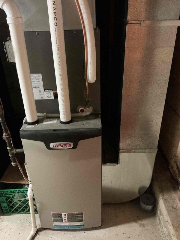 Performed comprehensive AC tuneup on Lennox system. Inspected air filter and found it slightly dirty but serviceable. Flushed evaporator drain line and removed debris from drain pan. Removed outdoor unit panels to inspect all electrical components and connections, which were found to be in good condition. Cleaned and rinsed condenser coils thoroughly. Reassembled unit and verified system operation with 22-degree temperature split across evaporator coil, confirming proper cooling performance.