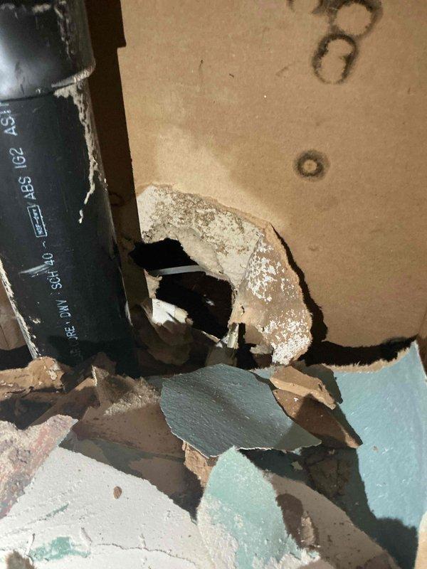 # Emergency Plumbing Repair - Burst Ice Maker Supply Line

Responded to emergency water leak in basement caused by failed ice maker supply line. Upon arrival, water supply had been shut off to prevent further damage. Assessed the situation and confirmed the refrigerator ice maker line had cracked, resulting in active water intrusion.

Removed the damaged ice maker supply line and installed new shut-off valve to provide dedicated isolation capability for the appliance. Ran new supply line from shut-off valve to refrigerator connection point, ensuring proper routing and secure fittings throughout. Tested system for leaks under full pressure and verified proper water flow to ice maker unit.

Wall damage was evident around the pipe penetration area where water had compromised the drywall integrity. Documented existing conditions with photographs for insurance claim purposes, showing the extent of water damage to wall materials and the compromised plumbing components.

All connections were 