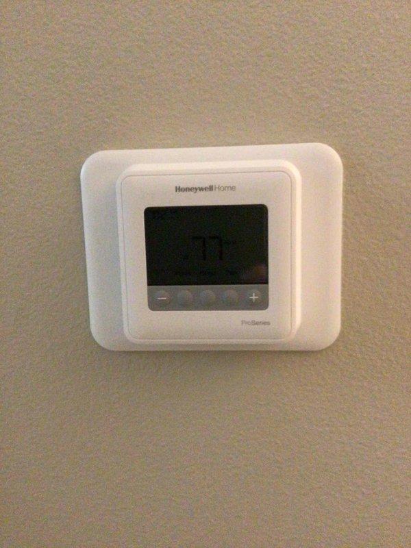 Installed a Honeywell Home ProSeries T4 programmable thermostat to replace the existing unit. Removed the old thermostat, mounted and leveled the new wall plate, connected the wiring, and secured the new thermostat to the wall. Verified proper operation of heating, cooling, and fan modes upon completion.