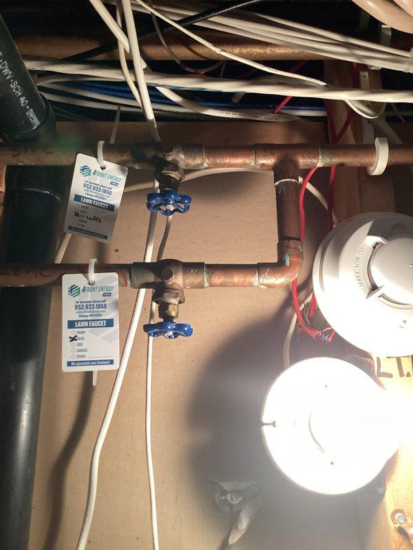 Responded to water leak in utility room originating from pipe connected to outside faucet. Upon arrival, water supply was already shut off. Inspection revealed leaking inside hose bib valves caused by loose bleeder valve caps that had not been properly tightened. Tightened all bleeder valve caps to manufacturer specifications, resolving the leak issue.