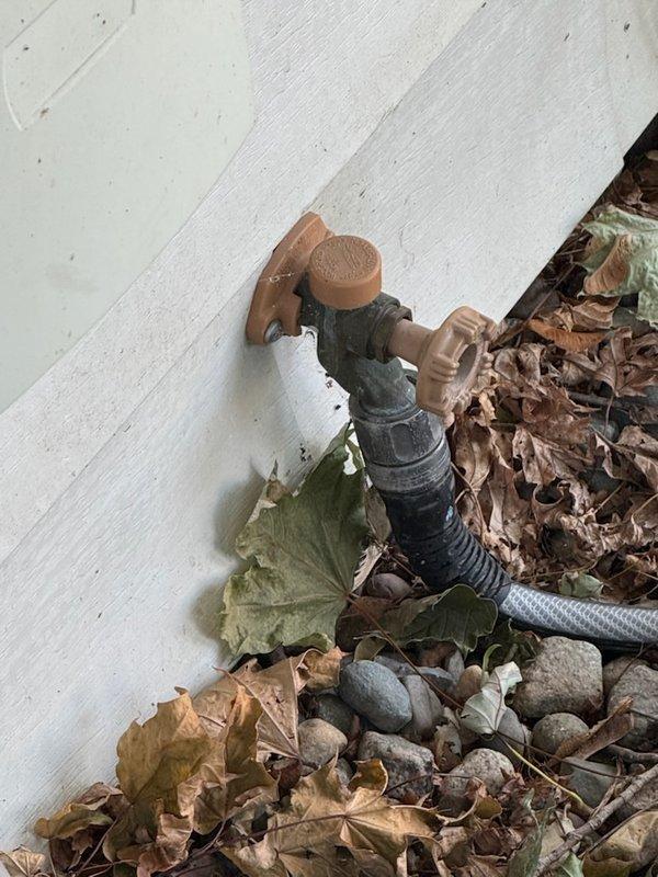 Responded to service call for toilet leak and slow bathroom drain. Upon inspection, identified cracked toilet tank as source of leak. Discussed replacement options and solutions with customer, explaining that tank replacement would be necessary to resolve the leak issue. Assessed bathroom sink drain flow and outdoor hose bibs per customer request for potential shut-off valve installation. Documented conditions with photos showing existing outdoor spigot configuration and bathroom sink plumbing. Prioritized toilet leak repair as immediate concern due to water waste and potential damage.