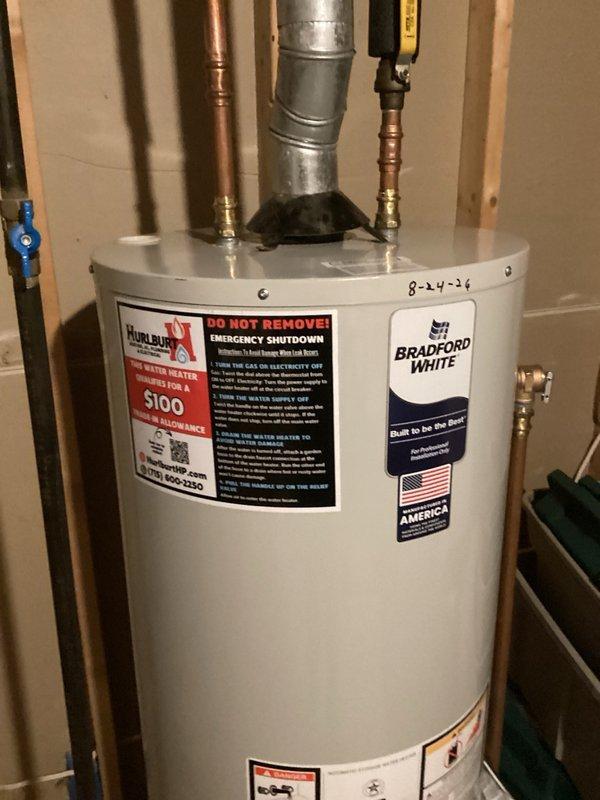 Responded to no hot water complaint and determined the original 40-gallon natural gas water heater had reached end of life and required replacement. Removed existing failed unit and installed new Bradford White 40-gallon natural gas water heater. Connected hot and cold water supply lines with proper brass fittings, installed pressure relief valve with discharge piping, and attached galvanized vent pipe for proper exhaust ventilation. Verified all connections for leaks, tested unit operation, and confirmed hot water delivery. Installation completed in unfinished utility area with all plumbing connections secured and system fully operational.