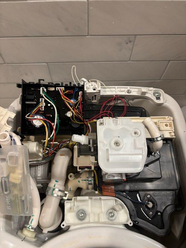 Responded to service call for malfunctioning Toto Neorest 750H toilet with integrated bidet system. Upon inspection, diagnosed failed flush valve and bowl controller affecting lower bowl operation. Removed defective components and installed new OEM flush valve assembly and bowl controller unit. Reconnected all electrical wiring harnesses and plumbing connections to internal control systems. Performed operational testing of all toilet functions including flush cycles, bidet spray settings, and electronic controls. Verified proper water flow, drainage, and sensor response. Cleaned work area and confirmed unit restored to full working order with all functions operating as designed.