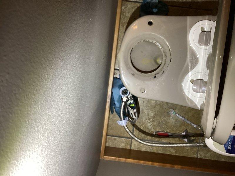 Responded to a reported water leak from the side of a powder bathroom toilet during flushing. Upon inspection, identified a failed tank-to-bowl gasket on a Kohler toilet as the source of the leak. Replaced the defective gasket with a new tank-to-bowl seal and securely tightened all water supply line fittings to ensure proper connections and prevent future leaks.