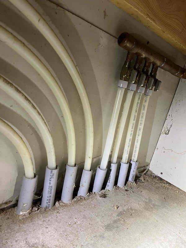 Responded to water leak in garage radiant floor heating system served by water heater that had been inactive for four years with no system pressure. Upon inspection, discovered bees had built nests in the piping and down the flue pipe of the water heater, creating an unsafe condition and potential fire hazard if unit were to be started. Inspected PEX distribution manifold and radiant floor heating lines for visible damage. Advised homeowner on leak detection procedure: pressurize the hydronic heating system, disable water heater operation, allow circulation pump to run, and monitor pressure over several days to determine if leak exists in the radiant floor loops. Documented condition of water heater base assembly showing significant corrosion on combustion chamber and deteriorated flue connections. Recommended complete water heater replacement due to bee infestation in flue pipe and safety concerns before attempting to restore system operation. Homeowner to decide on proceeding with re