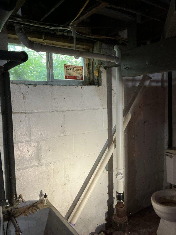 Responded to a leaking kitchen sink drain caused by severely deteriorated galvanized piping. The galvanized pipe connecting the kitchen sink drain to the branch drain had disintegrated and was heavily pitted with rust corrosion. Removed several feet of failed cast iron and galvanized pipe from the basement area. Installed new PVC waste line routed through the bottom of the kitchen sink cabinet, establishing proper connection to the kitchen sink drain and existing drainage system. New installation includes PVC P-trap configuration under double sink basin, ensuring proper drainage and long-term reliability. All affected piping replaced with code-compliant PVC materials to prevent future corrosion issues.