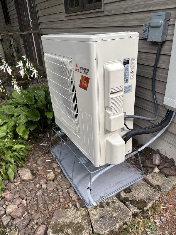 Completed warranty replacement of outdoor condensing unit with new Mitsubishi Electric condenser. Unit was installed on existing mounting platform with proper refrigerant line connections, electrical conduit routing, and disconnect box integration. System installation verified and unit left in operational condition.