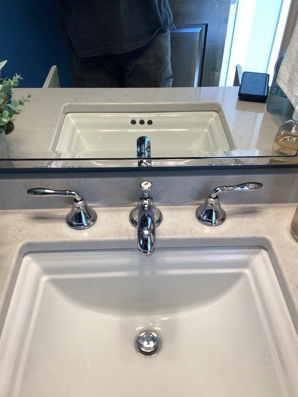 Responded to plumbing service call for water leak in master bathroom tub drain and loose faucet fixtures throughout the residence. Upon inspection, determined that the existing putty seal on the tub drain had deteriorated and failed, causing visible water leakage. Removed old putty material and applied fresh silicone sealant to the tub drain assembly to create a watertight seal. Additionally, addressed multiple loose widespread faucet installations in both the master bathroom and lower level bathroom, including loose mounting hardware and misaligned handles. Tightened all faucet components, realigned handles for proper operation, and secured mounting hardware on all affected fixtures. Tested all repairs to ensure proper function and verified leak resolution.