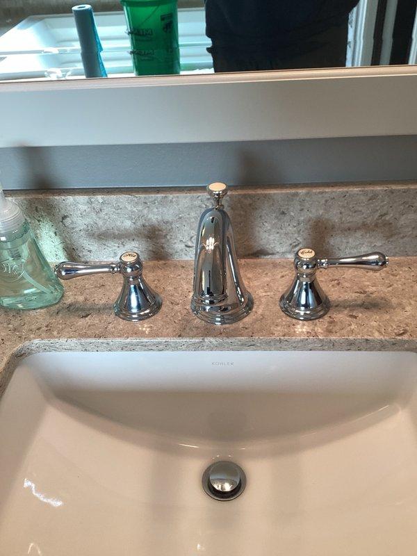 Responded to plumbing service call for water leak in master bathroom tub drain and loose faucet fixtures throughout the residence. Upon inspection, determined that the existing putty seal on the tub drain had deteriorated and failed, causing visible water leakage. Removed old putty material and applied fresh silicone sealant to the tub drain assembly to create a watertight seal. Additionally, addressed multiple loose widespread faucet installations in both the master bathroom and lower level bathroom, including loose mounting hardware and misaligned handles. Tightened all faucet components, realigned handles for proper operation, and secured mounting hardware on all affected fixtures. Tested all repairs to ensure proper function and verified leak resolution.