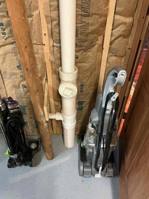Completed comprehensive plumbing inspection of residential property, examining all accessible plumbing systems, fixtures, and components. Inspected utility closet mechanical space containing water heater or expansion tank with proper wall-mounted securing straps, verified multiple supply and drainage lines including flexible hoses and rigid piping with brass fittings for proper installation and connections. Evaluated exposed plumbing infrastructure in unfinished wall cavity, including vertical PVC drainage pipe with appropriate hangers and supports through insulated stud bays. All findings documented with photographic evidence for service records.