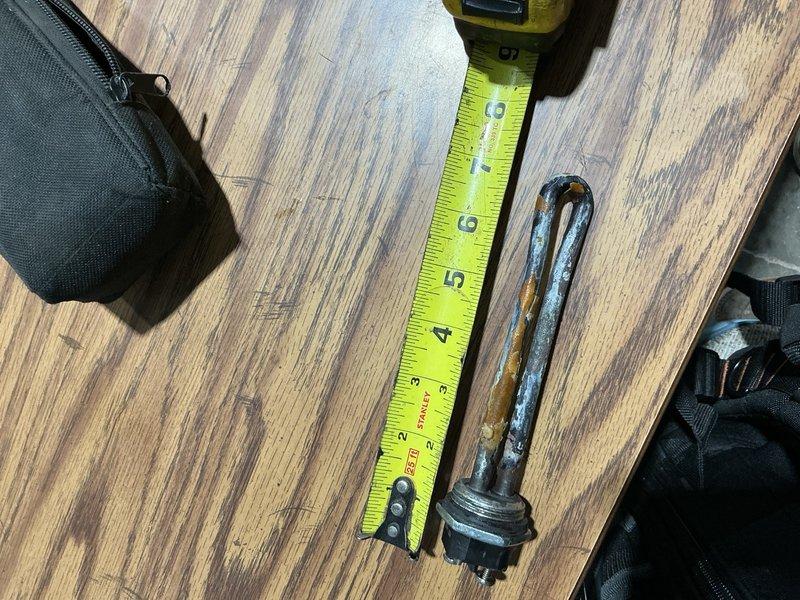 Responded to commercial property for no hot water issue on recently installed water heater. Upon inspection, diagnosed failed heating element with severe corrosion and mineral deposit buildup. Removed defective heating element and documented condition. Submitted purchase order request for replacement heating element to restore hot water service to business.