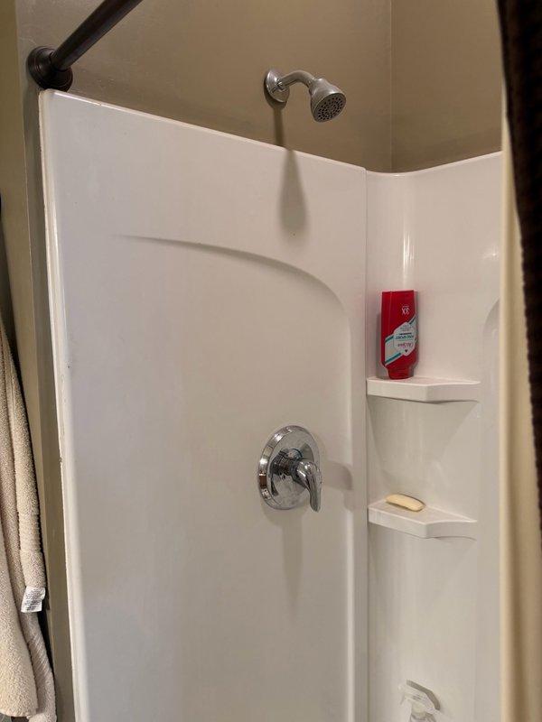 Responded to service call for multiple plumbing issues including broken garbage disposal causing kitchen sink backup, malfunctioning shower cartridge resulting in hot water temperature control problems, and failed toilet components. Cleared kitchen sink drain line to restore proper drainage. Replaced defective shower cartridge with new unit to restore proper hot water temperature control and mixing valve function. Installed new fill valve assembly in toilet tank to address water flow issues and replaced toilet seat. All fixtures tested and verified operational upon completion.
