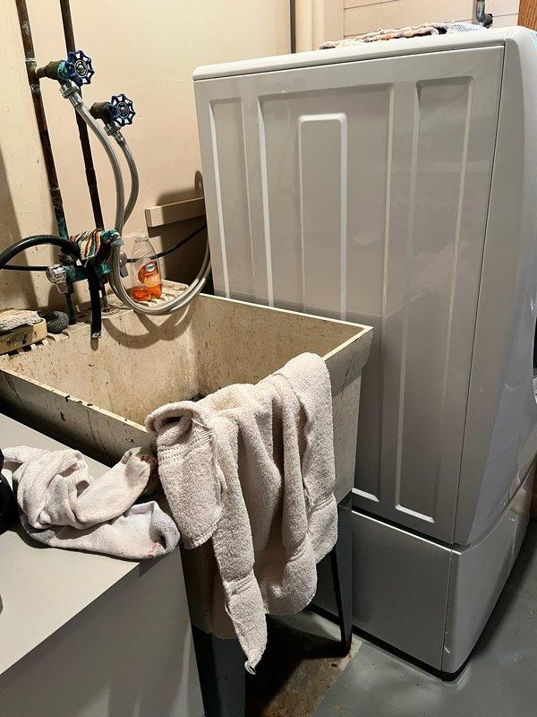 Responded to a clogged floor drain beneath the washing machine that was causing standing water in the laundry area. Upon arrival, diagnosed the floor drain as completely blocked with debris, preventing proper drainage. Cabled the floor drain line to clear all obstructions and restored full drainage capacity, then tested the system to verify proper operation. Additionally, installed a customer-supplied laundry tub with faucet, making all necessary water supply line connections with proper shut-off valves. Conducted multiple fill-and-drain tests to ensure leak-free operation and confirmed all fixtures were functioning correctly with no water leaks present at the completion of the service.