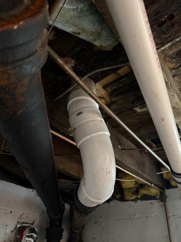 Responded to a water leak complaint where the basement PVC drain pipe was dripping when the main floor toilet was flushed. Upon inspection, determined the toilet was leaking due to a failed wax ring seal at the base. Removed and reset the toilet with a new wax ring, eliminating the leak and restoring proper drainage function.
